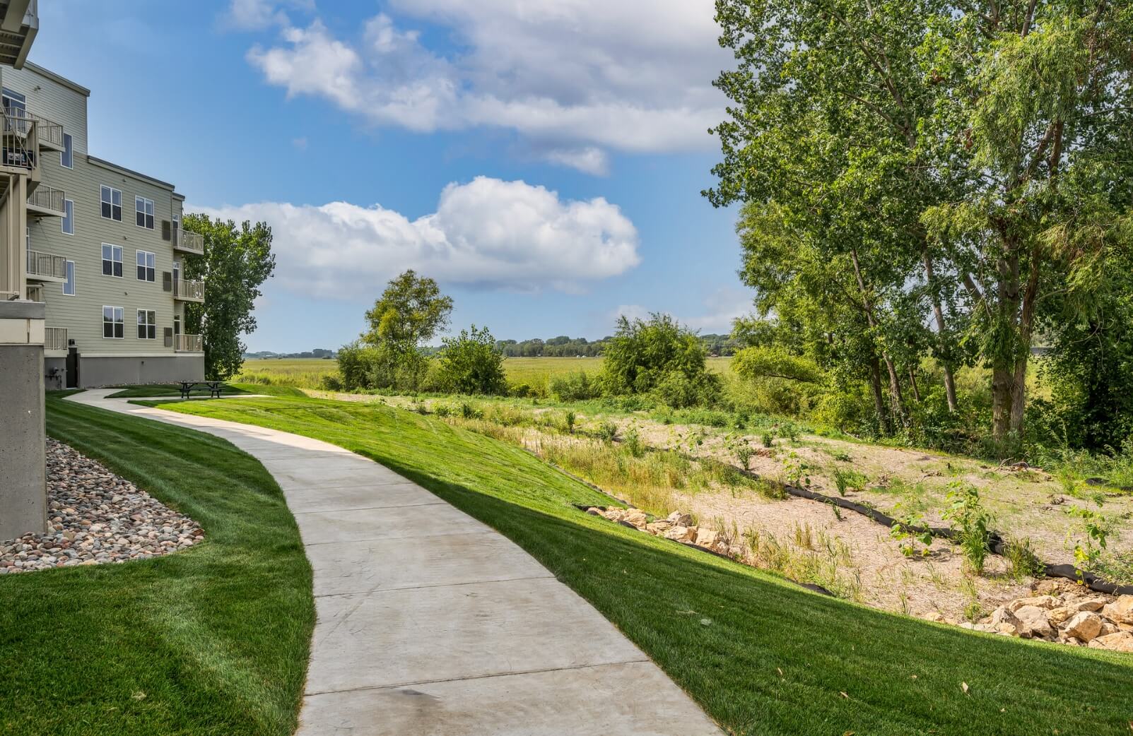 the sidewalk running along the back of the sand creek flats building