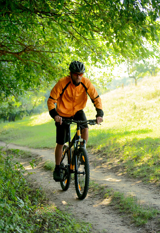 a man mountain biking on a trail