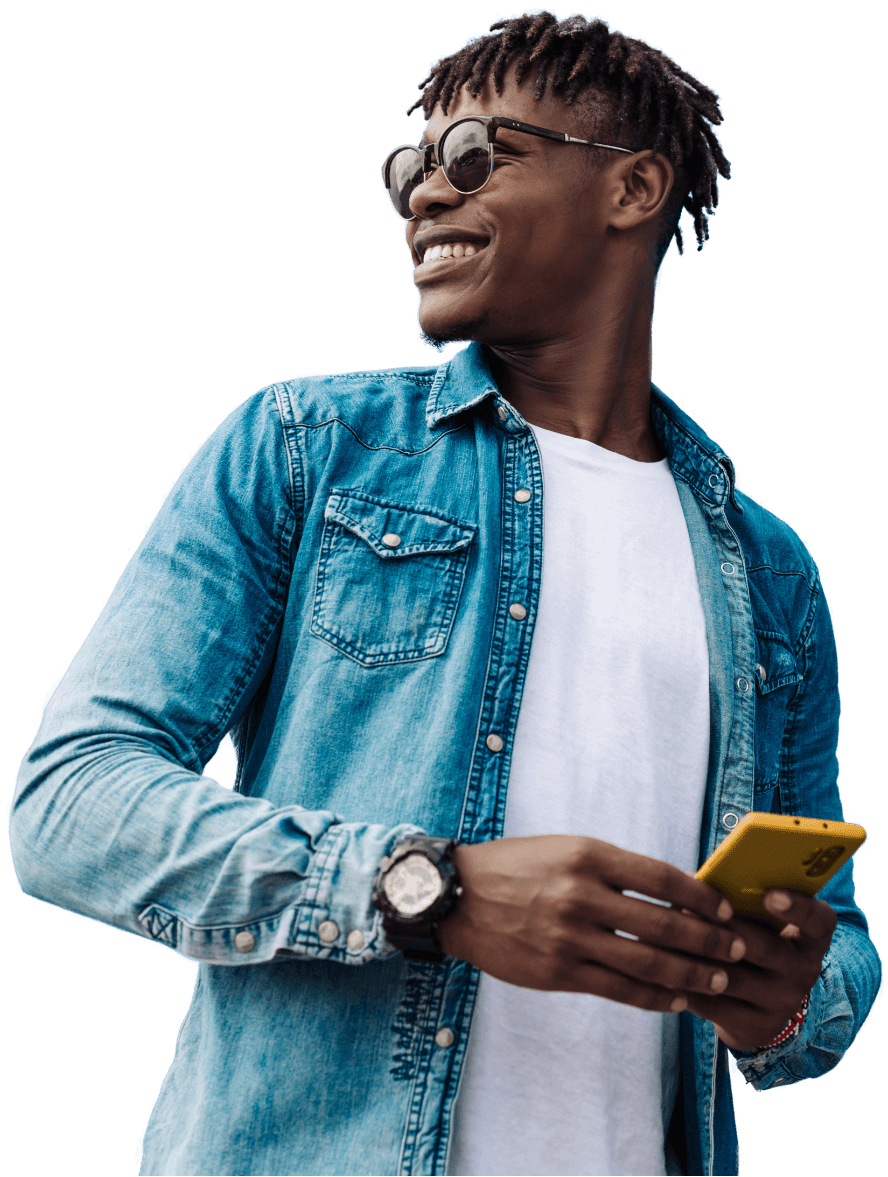 a young man smiling and on his phone